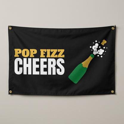 Pop Fizz Cheers flag 3x5 in black with a bubbly bottle popping its cork, hung on a wall