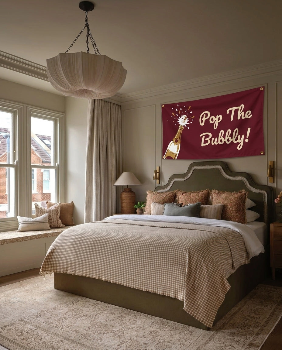 Pop The Bubbly New Year's wall flag hanging in a bedroom