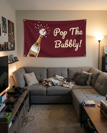 Pop The Bubbly flag decorating a game room wall