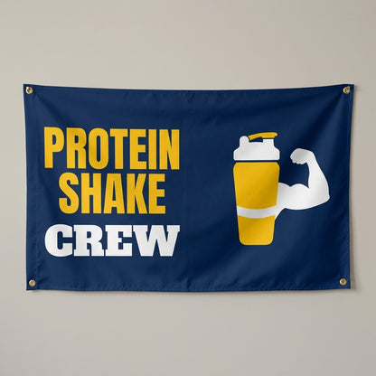 Protein Shake Crew flag 3x5 in navy with a yellow shaker bottle and flexed arm, hung on a wall