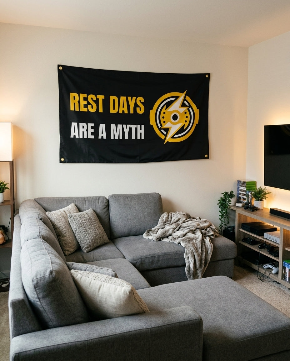 Rest Days Are A Myth flag decorating a game room wall