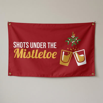 Shots Under The Mistletoe flag 3x5 in red with clinking shot glasses under mistletoe, hung on a wall