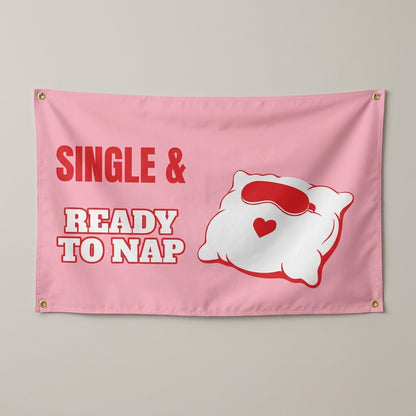 Single And Ready To Nap flag 3x5 in pink with a pillow and red sleep mask, hung on a wall