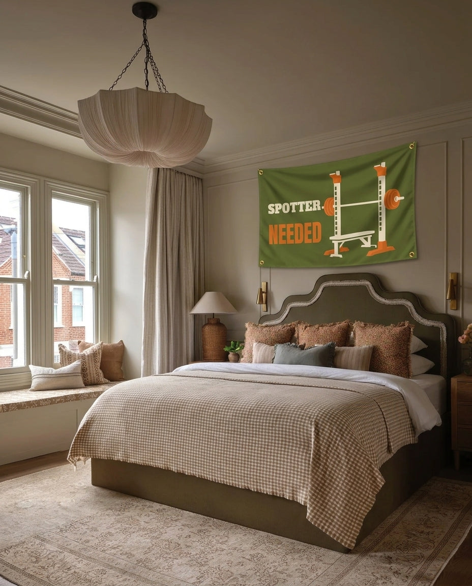 Spotter Needed gym wall flag hanging in a bedroom