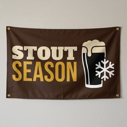 Stout Season flag 3x5 in brown with a pint of dark beer and a snowflake, hung on a wall