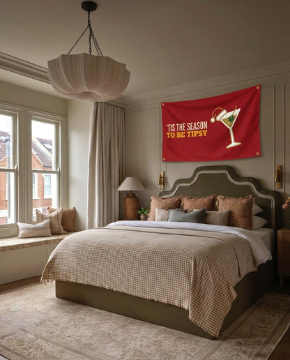 Tis The Season To Be Tipsy Christmas wall flag hanging in a bedroom