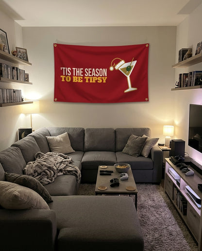 Tis The Season To Be Tipsy flag decorating a game room wall