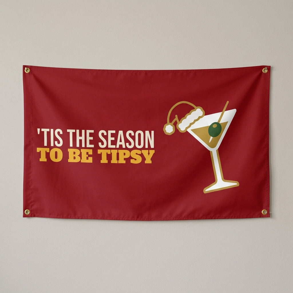 Tis The Season To Be Tipsy flag 3x5 in red with a cocktail in a tiny Santa hat, hung on a wall