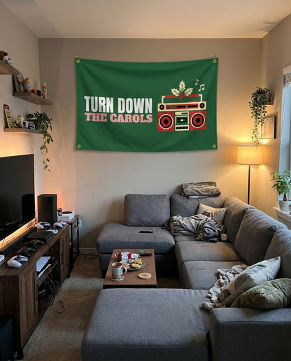 Turn Down The Carols flag decorating a game room wall