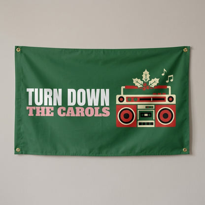 Turn Down The Carols flag 3x5 in dark green with a boombox with holly, hung on a wall