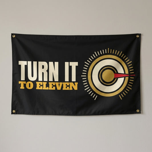 Turn It To Eleven flag 3x5 in black with a gold volume knob, hung on a wall