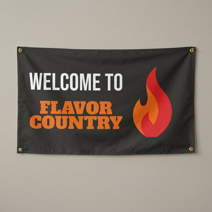 Bring The Heat flag 3x5 in black with a big orange flame, hung on a wall