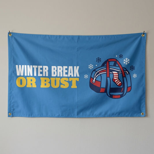 Winter Break Or Bust flag 3x5 in blue with a packed duffel bag, hung on a wall